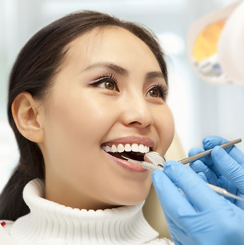 woman smiling at the dentist teeth cleaning